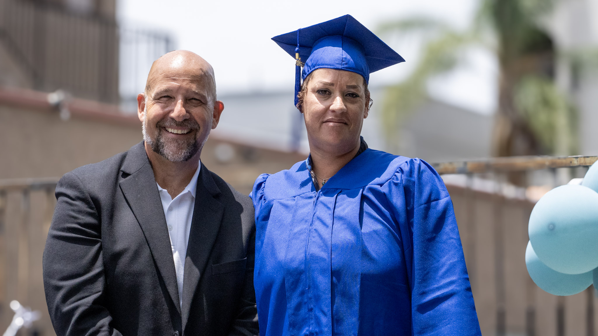 Damien Weston presenting a diploma to a graduate