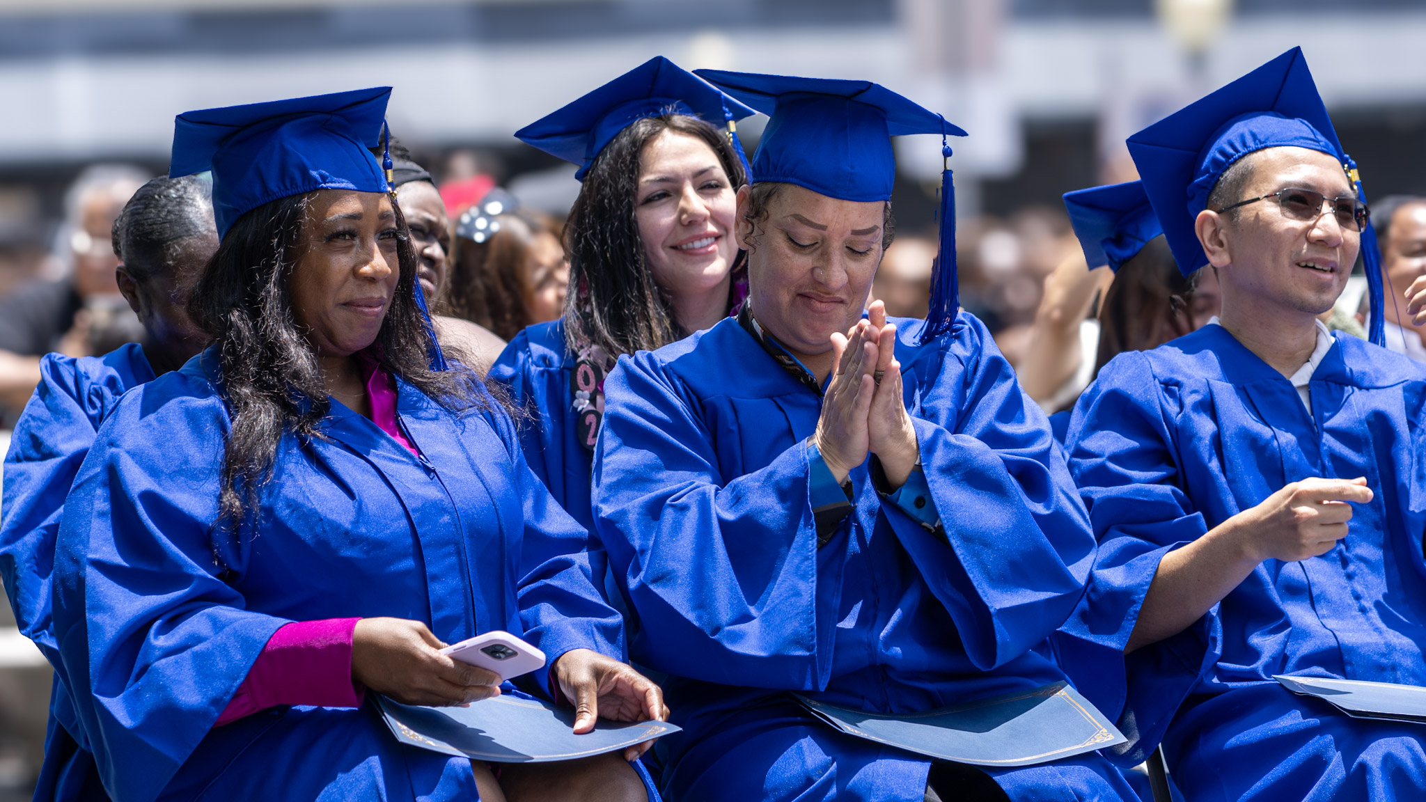 Graduates laughing together during the ceremony