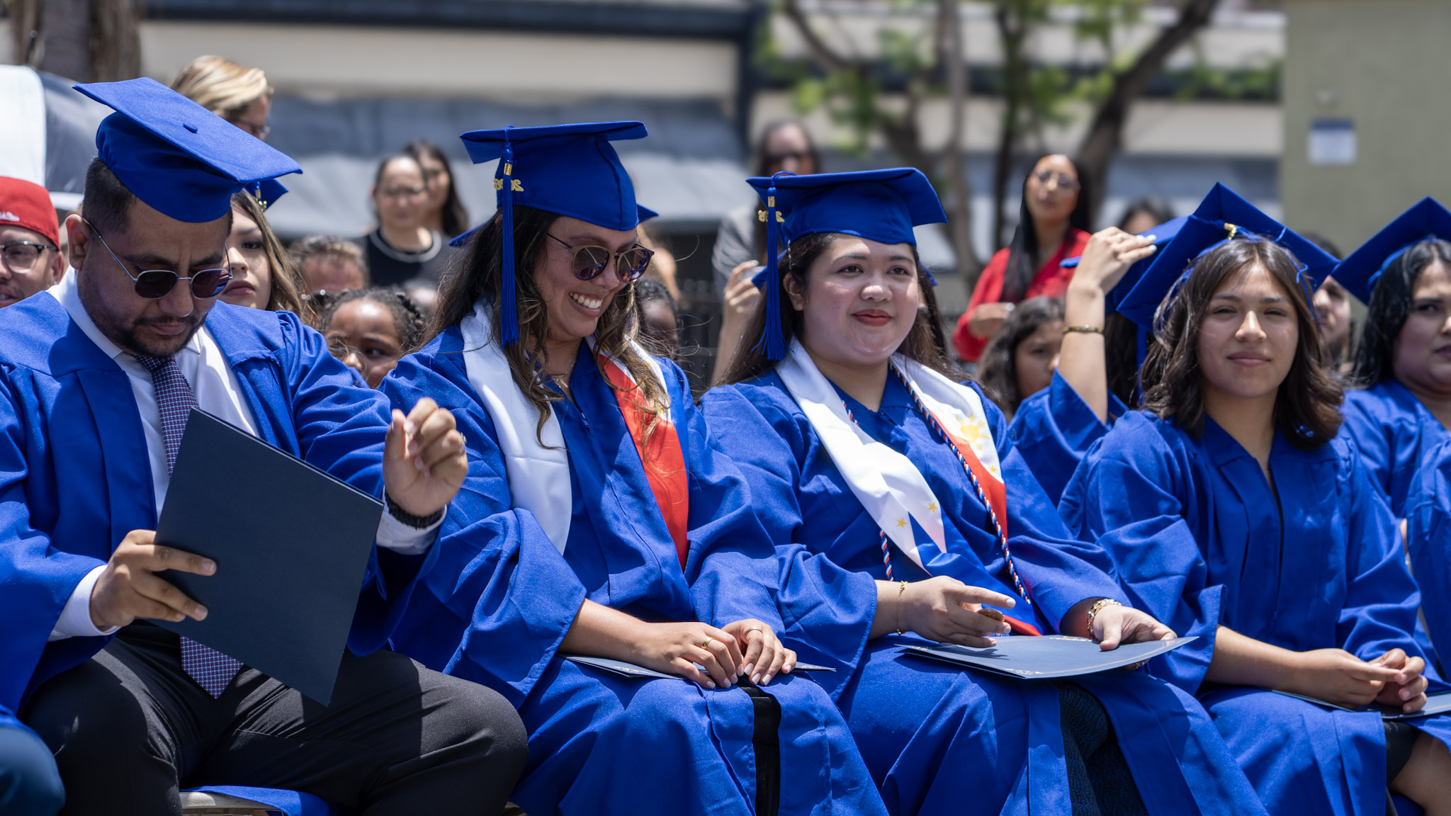 Graduates laughing and celebrating together after commencement